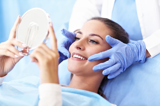 Picture of adult woman having a visit at the dentist's