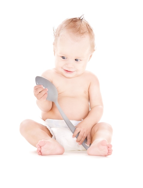 picture of baby boy with big spoon over white