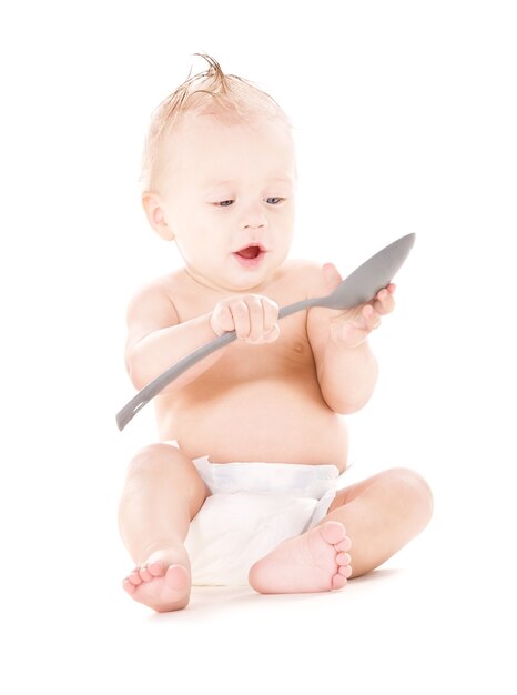 picture of baby boy with big spoon over white