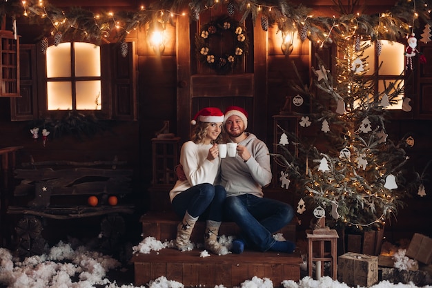 Picture of beautiful caucasian woman with her boyfriend celebrate christmas together at home