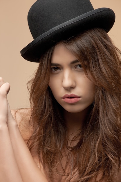 picture of beautiful topless woman in bowler hat