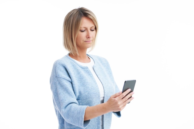 Picture of blonde woman over back isolated background with mobile phone