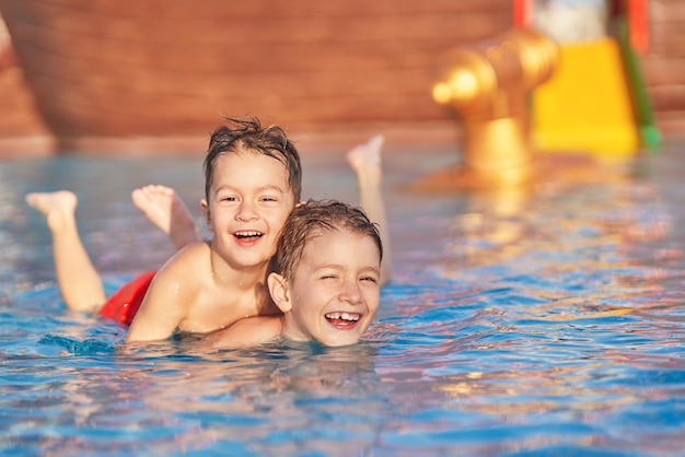 Picture of brothers playing in outdoor aqua park pool