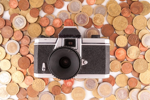 Photo picture of a business money concept idea, photo camera and coins