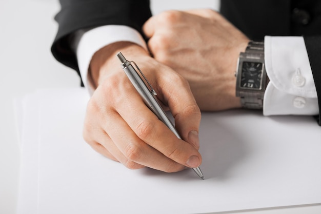 picture of businessman writing something on the paper