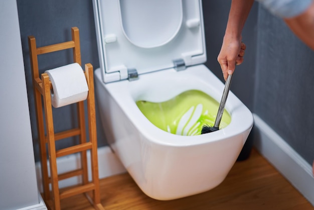 Picture of cleaning toilet seat with chemicals