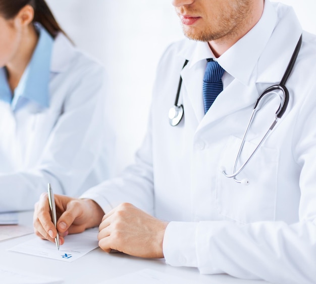 picture of doctor and nurse writing prescription paper