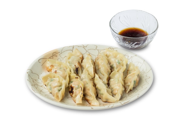 Picture of dumplings or gyozas with soy sauce isolated on white background