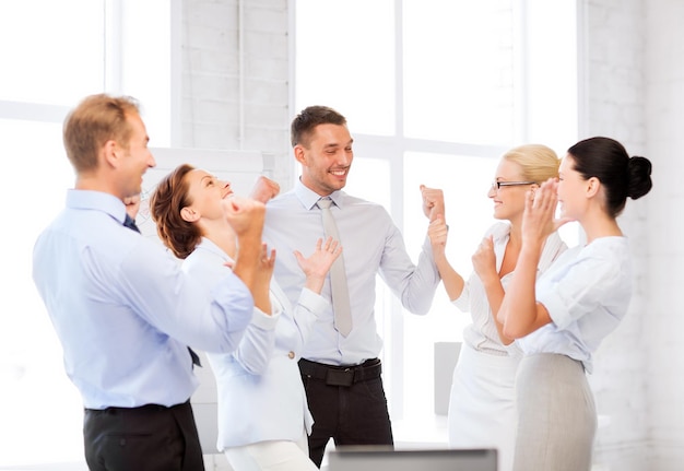 picture of happy business team celebrating victory in office