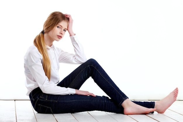 Picture of happy teenage girl sitting on the floor