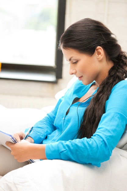 picture of happy woman with big notepad