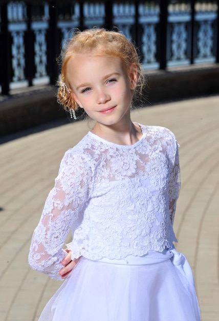 Picture of a little girl in white dress posing outdoor