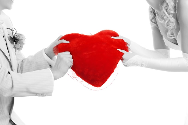 Picture of loving couple with red heart in their hands