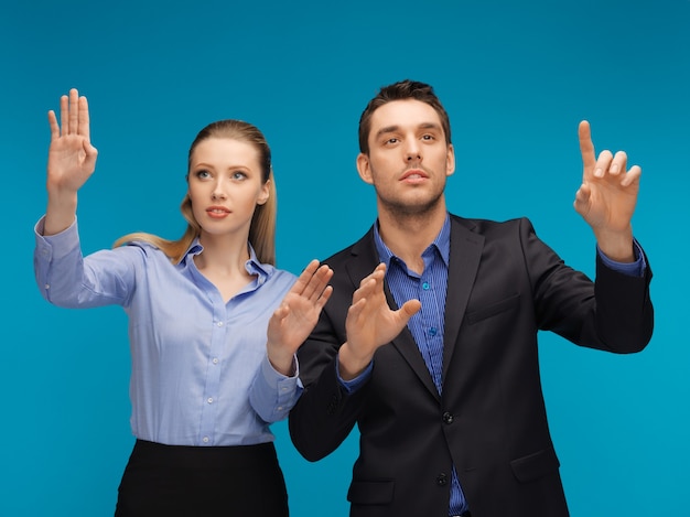 picture of man and woman working with something imaginary.