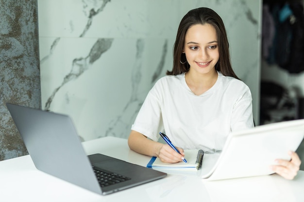 Picture of serious concentrated young housewife paying bills for rent, gas and electricity, feeling frustrated, trying hard to make ends meet. Finance, debts, financial crisis and home budget