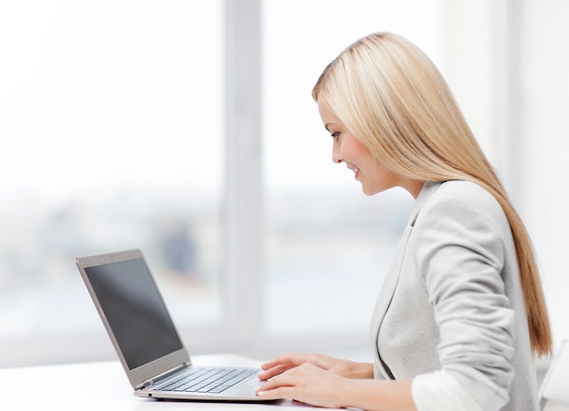 picture of smiling businesswoman using her laptop computer