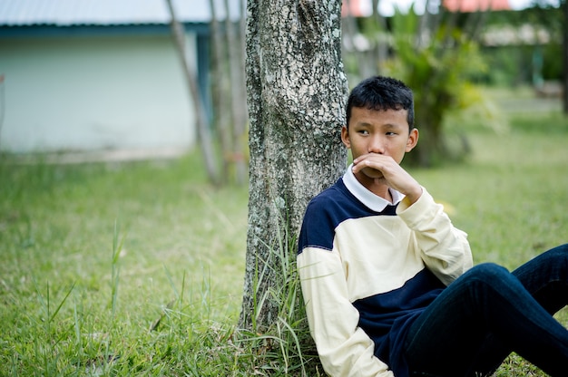 Picture of a young boy sitting waiting for someone Waiting concept