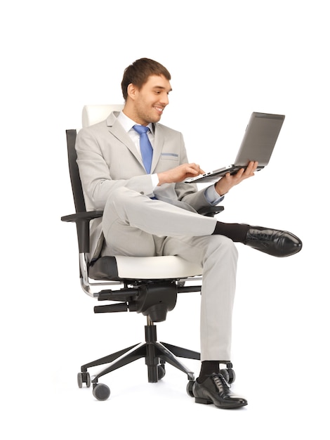 picture of young businessman sitting in chair with laptop