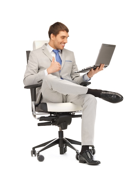 picture of young businessman sitting in chair with laptop