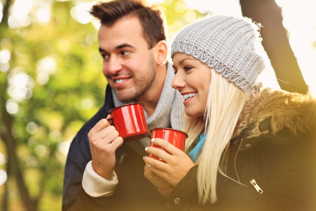 A picture of a young couple drinking tea outdoors