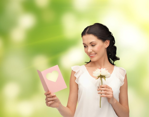 picture of young woman holding flower and postcard