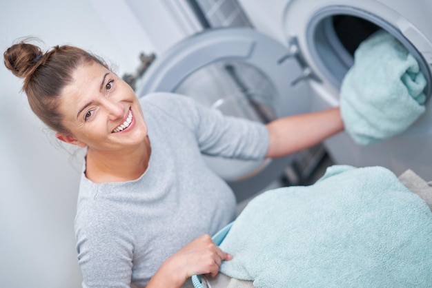 Picture of young woman making laundry work