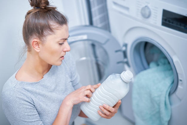 Picture of young woman making laundry work