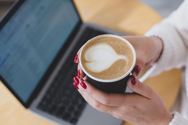 Pictures of women's hands holding a paper cup of coffee.