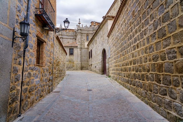 Picturesque alley of old stone houses next to the cathedral of Avila, Spain.