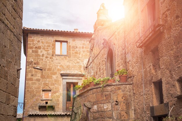 Picturesque building in medieval town in Tuscany Italy Old stone walls and plants