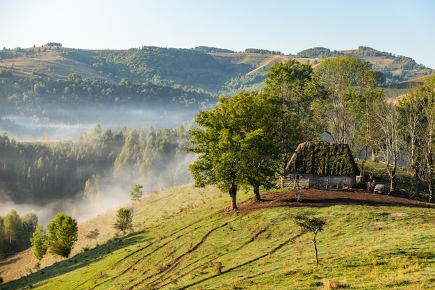 Picturesque landscape with old traditional house on hill