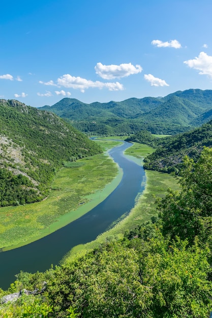 The picturesque meandering river flows among green mountains