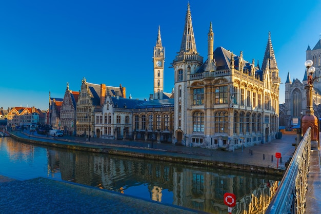 Picturesque medieval building and Post palace on the quay Graslei in Leie river at Ghent town at morning, Belgium