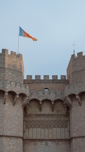 Picturesque medieval towers in the city of Valencia with flag