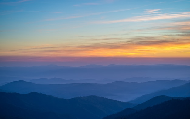 The picturesque mountain landscape on the sunset background