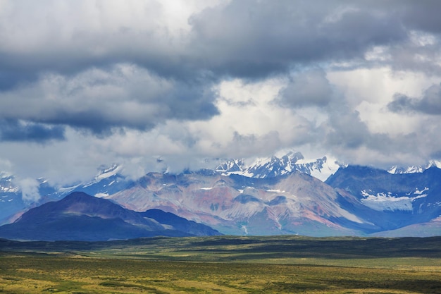 Picturesque Mountains of Alaska in summer. Snow covered massifs, glaciers and rocky peaks.