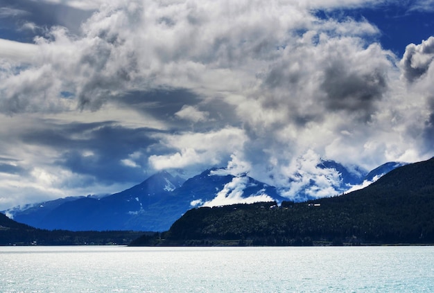 Picturesque Mountains of Alaska in summer. Snow covered massifs, glaciers and rocky peaks.