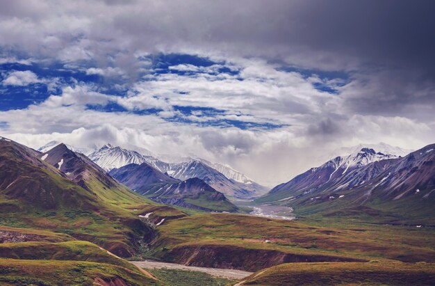 Picturesque Mountains of Alaska in summer. Snow covered massifs, glaciers and rocky peaks.