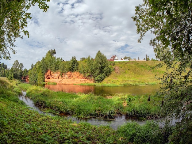 Picturesque red bank of the Oredezh river Geological exposure of the Devonian on the Oredezh River