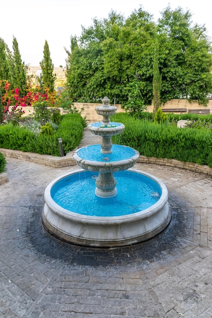 Picturesque refreshing fountain in the spring garden