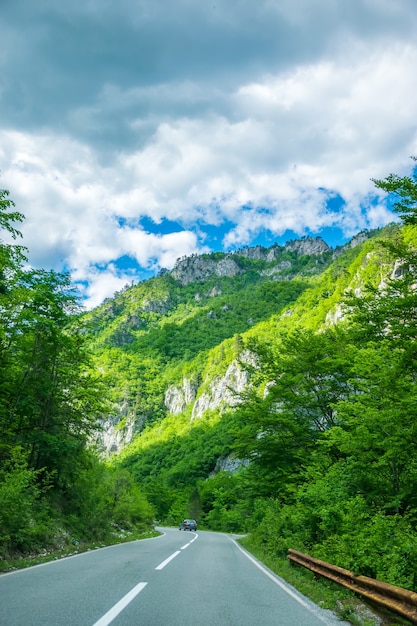 A picturesque road passes through the mountains and canyons in Montenegro.