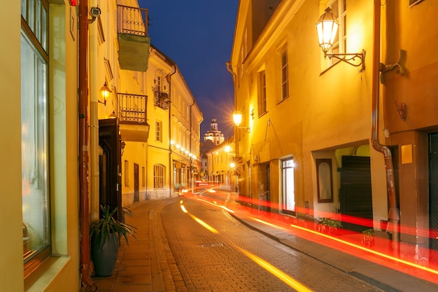 Picturesque Street and luminous track from the car at night in Old Town of Vilnius Lithuania Baltic states