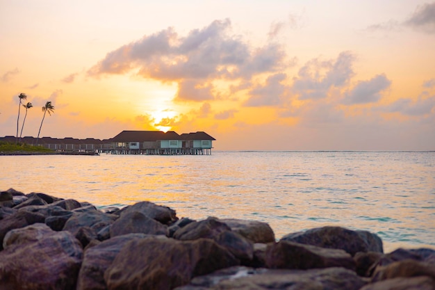 picturesque sunrise in the Maldive island, view on water villas at sunrise in Maldives