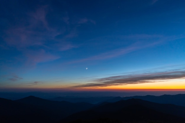 The picturesque sunrise above mountains. evening night time