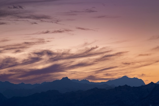 Picturesque sunset landscape on beach with colorful clouds and mountains in background Dahab Egypt