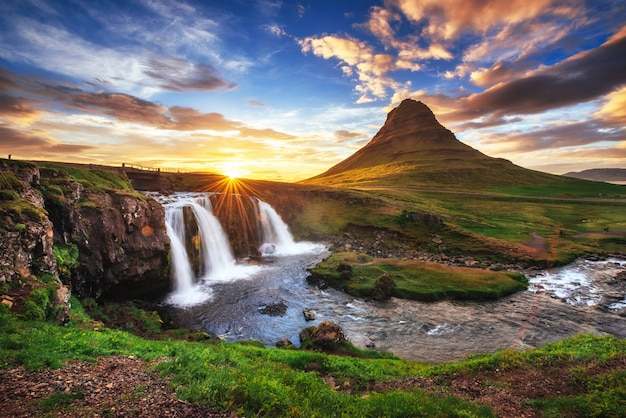 The picturesque sunset over landscapes and waterfalls.