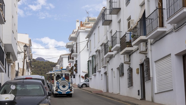 Picturesque town of Frigiliana located in mountainous region of Malaga with touristic train.