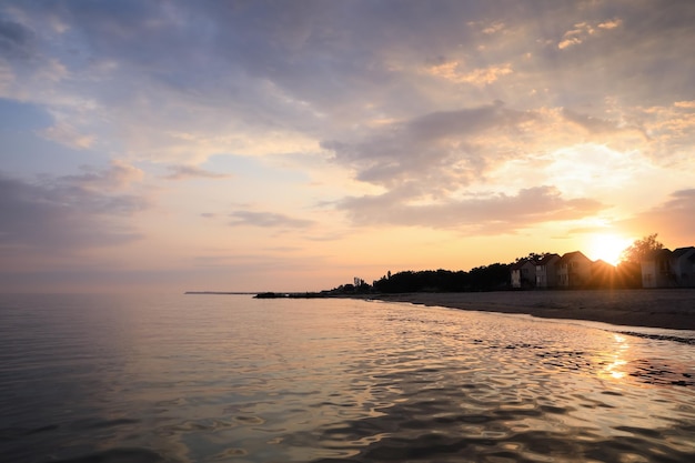 Picturesque view of sea and coast at sunset