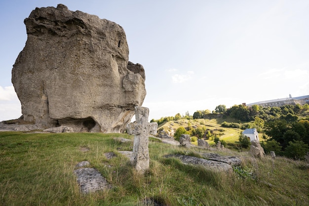 Pidkamin inselberg stone on hill and ancient graveyard Ukraine