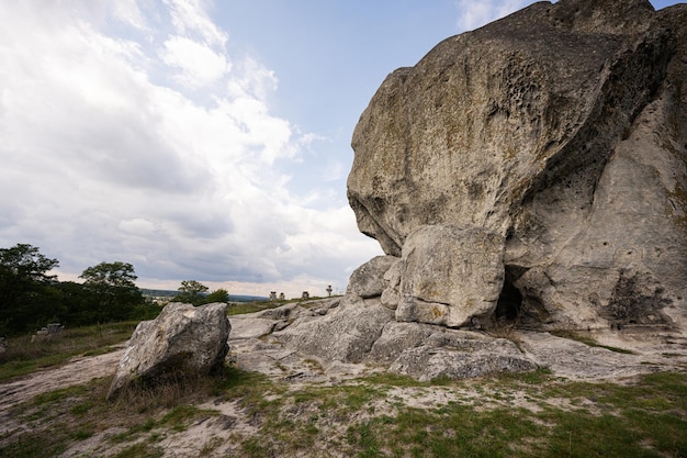 Pidkamin inselberg stone on hill and ancient graveyard Ukraine